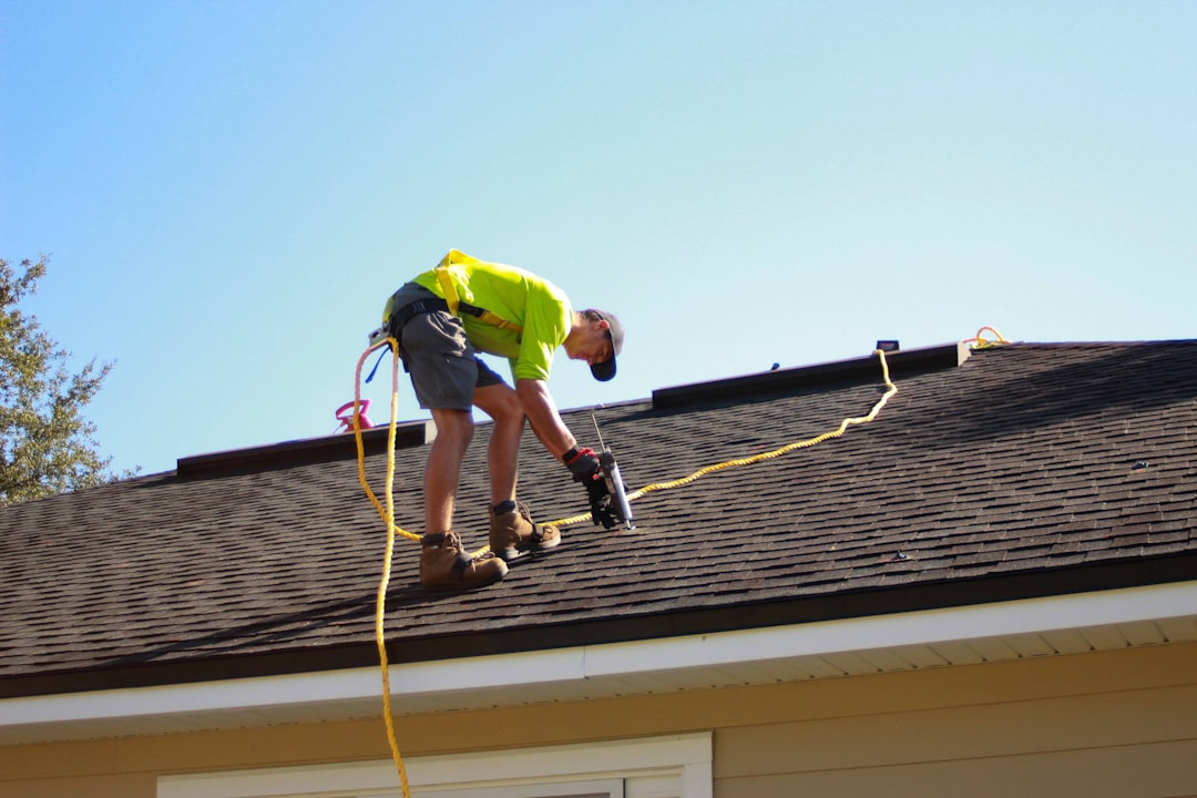Roofing contractor working at height on an Indiana job site without visible fall protection