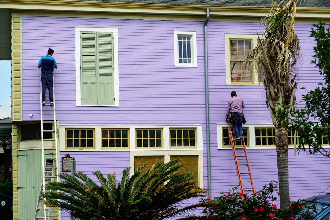 Siding contractor working at height on a Louisiana residential job site without visible fall protection