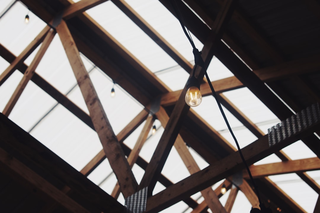 Framing contractor crew working on an unfinished roof structure in Virginia without fall protection