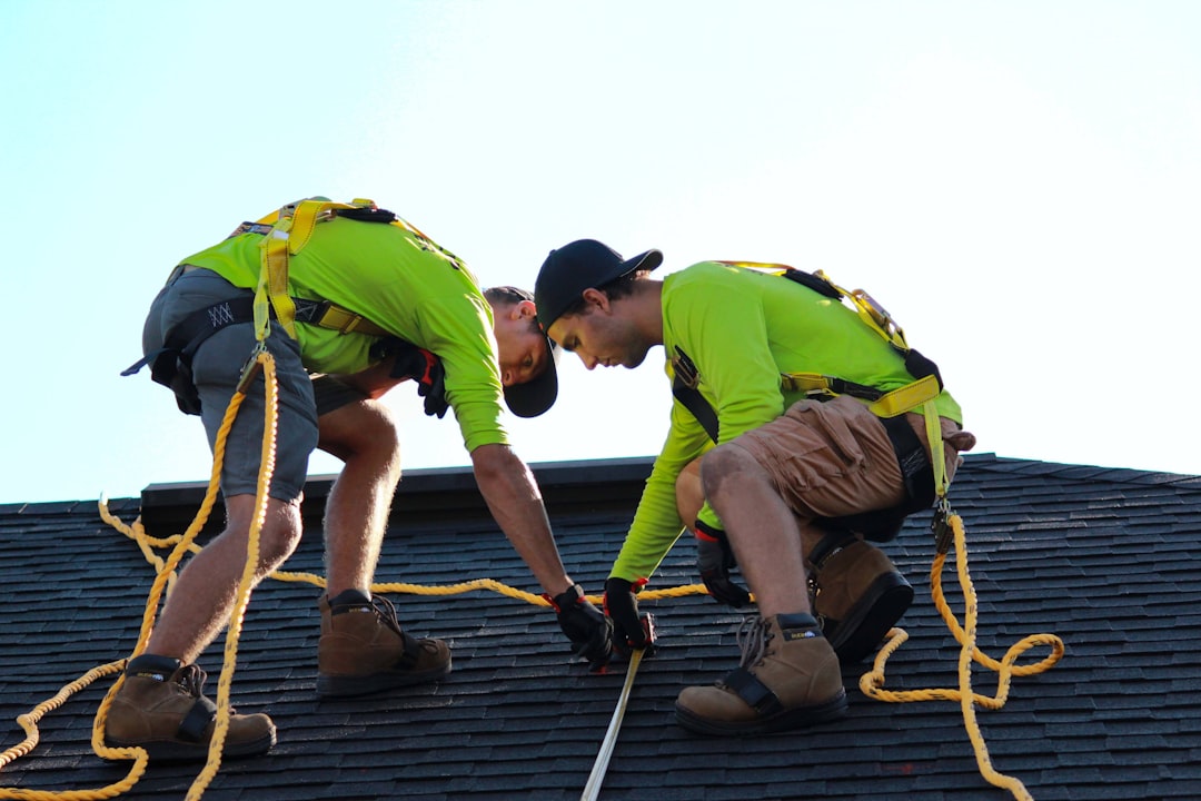 Residential construction worker on a rooftop without fall protection in Mississippi