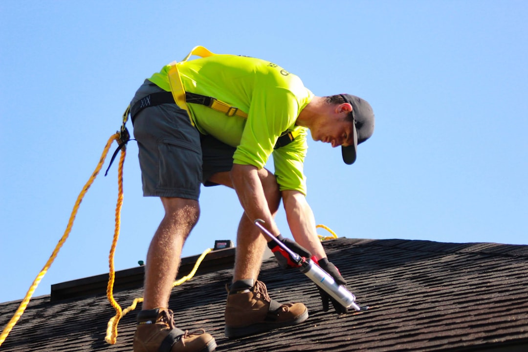 Roofing contractor using an extension ladder on a job site in Minnesota under OSHA 1926.1053 review