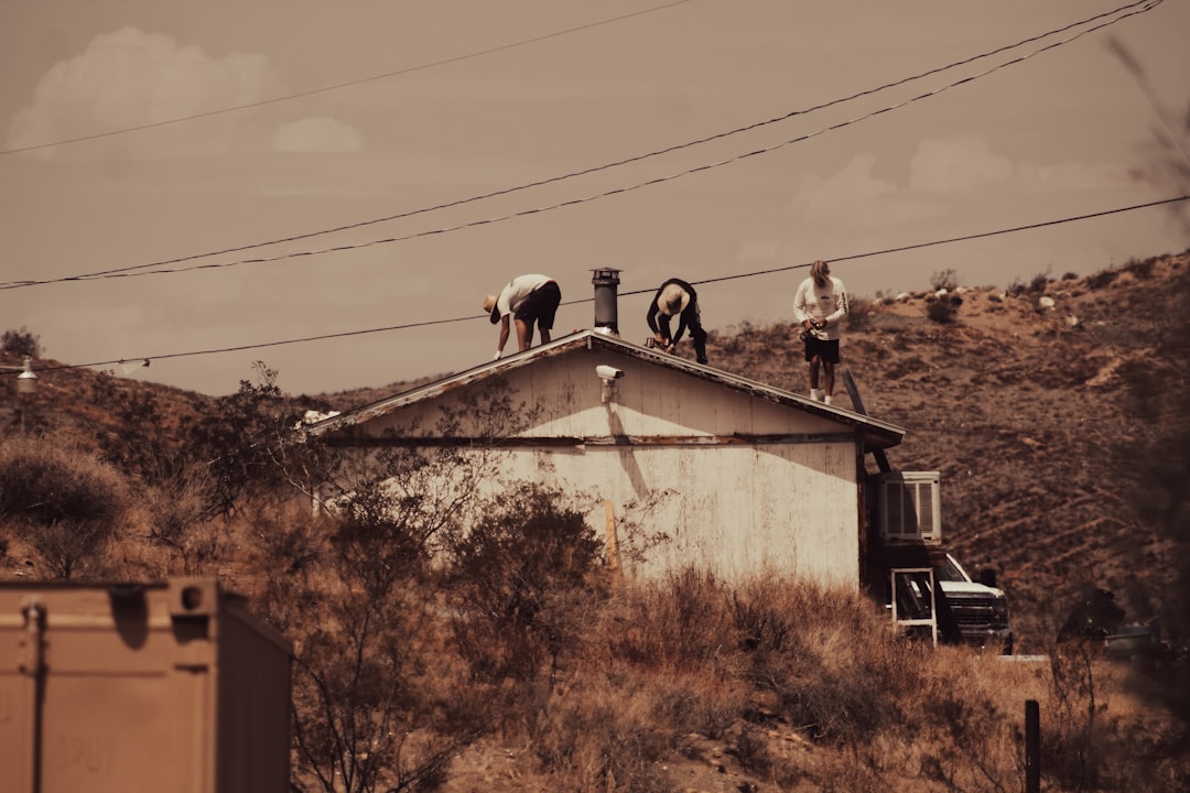 Roofing contractor on an extension ladder at a West Virginia construction site, illustrating an OSHA ladder violation citation