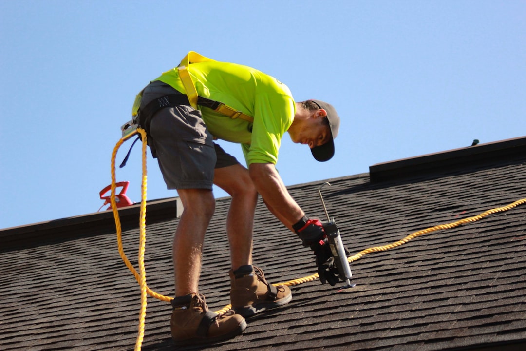 Roofing contractor using an extension ladder on a Texas job site during an OSHA ladder safety inspection
