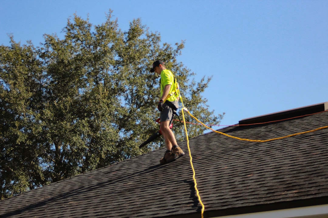 Roofing contractor working on a steep-slope roof in Minnesota without visible fall protection equipment