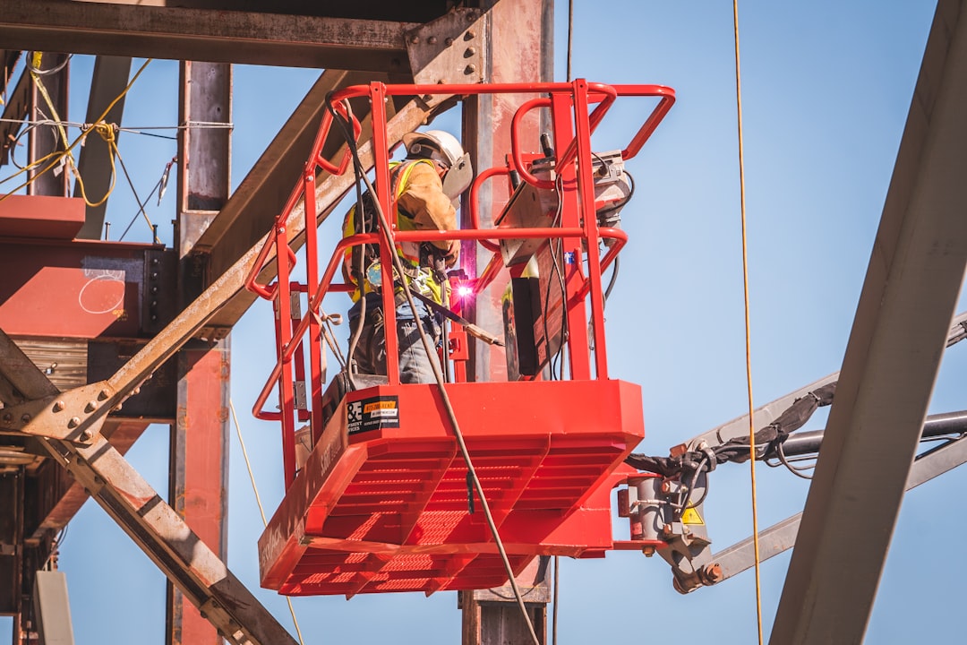 Construction worker at height on a Kentucky commercial building site without visible fall protection equipment