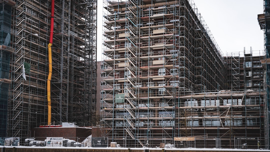 Framing contractor using an extension ladder on a North Carolina residential construction site