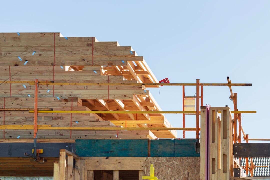 Framing contractor on an extension ladder at a construction site in Idaho, illustrating an OSHA ladder violation citation