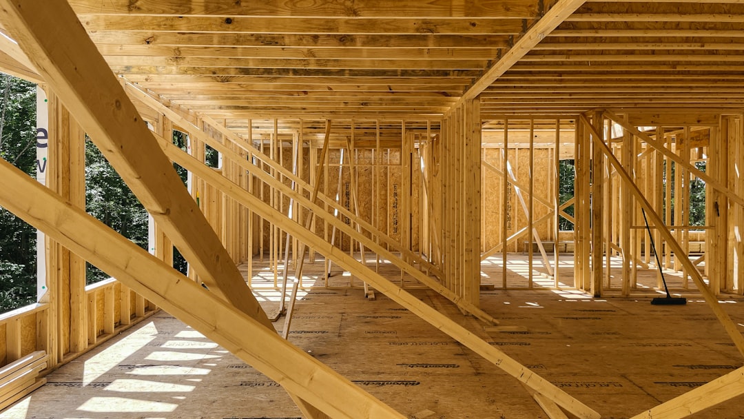 Framing contractor climbing an extension ladder on a South Carolina residential job site