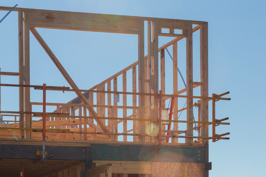 Scaffolding on a residential framing job site in Illinois showing guardrails and planking under OSHA 1926.451 rules