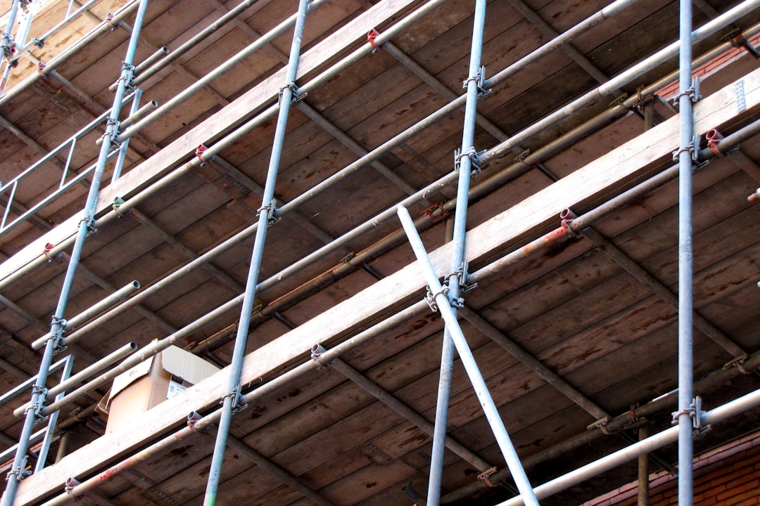Scaffolding erected on a construction site in Florida with workers securing guardrails