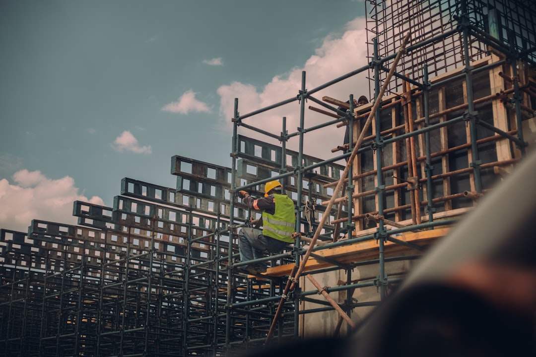 Residential construction crew working near scaffolding on a home exterior in Utah
