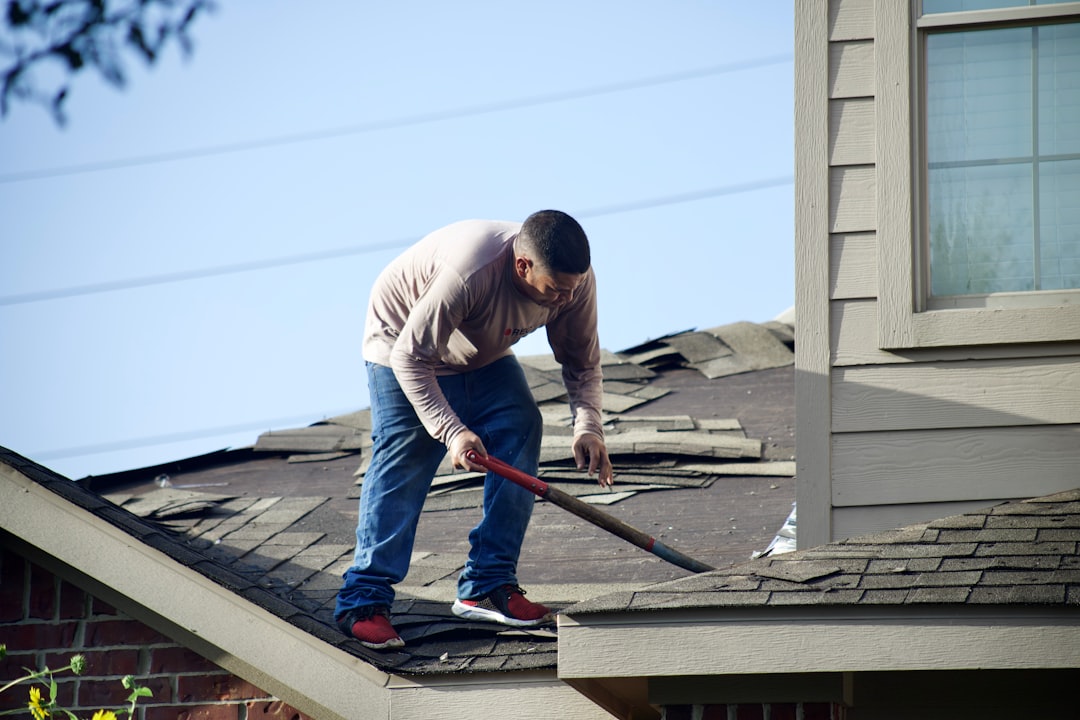 Roofing contractor working at height on a Wyoming residential job site without fall protection