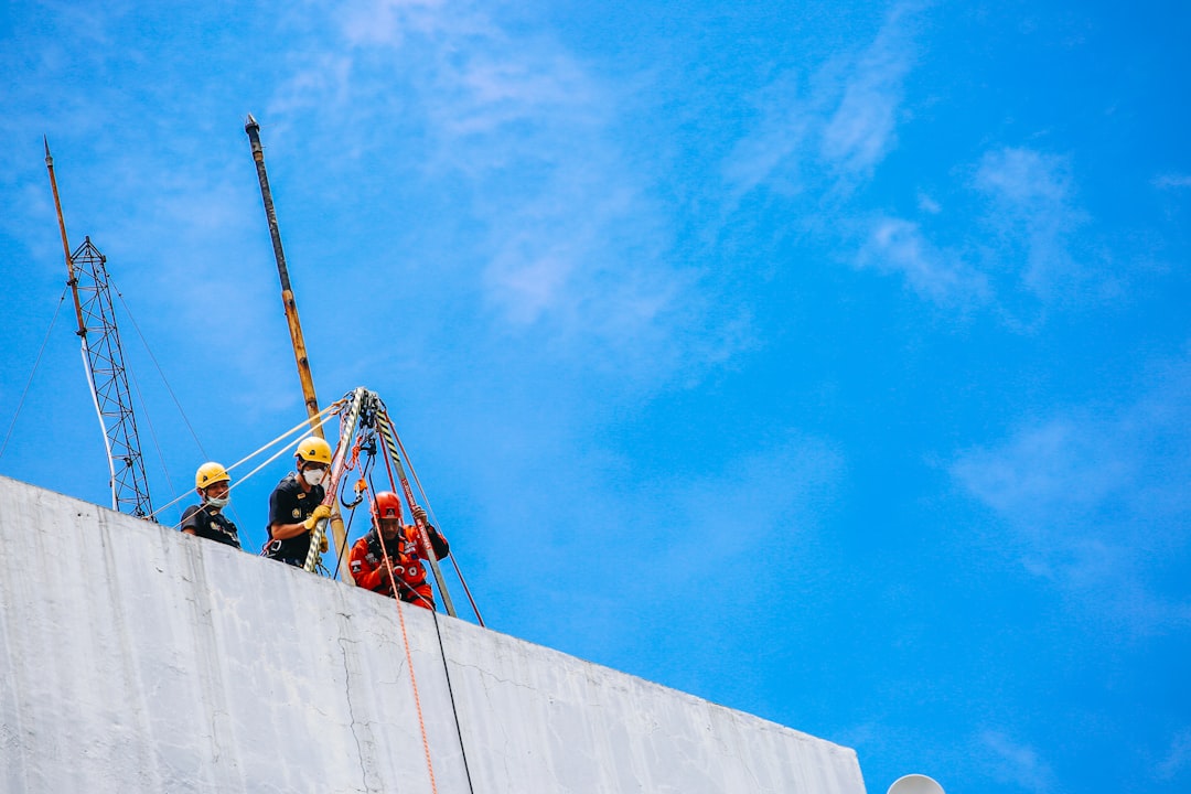 Roofing contractor working at height on a Colorado job site without visible fall protection