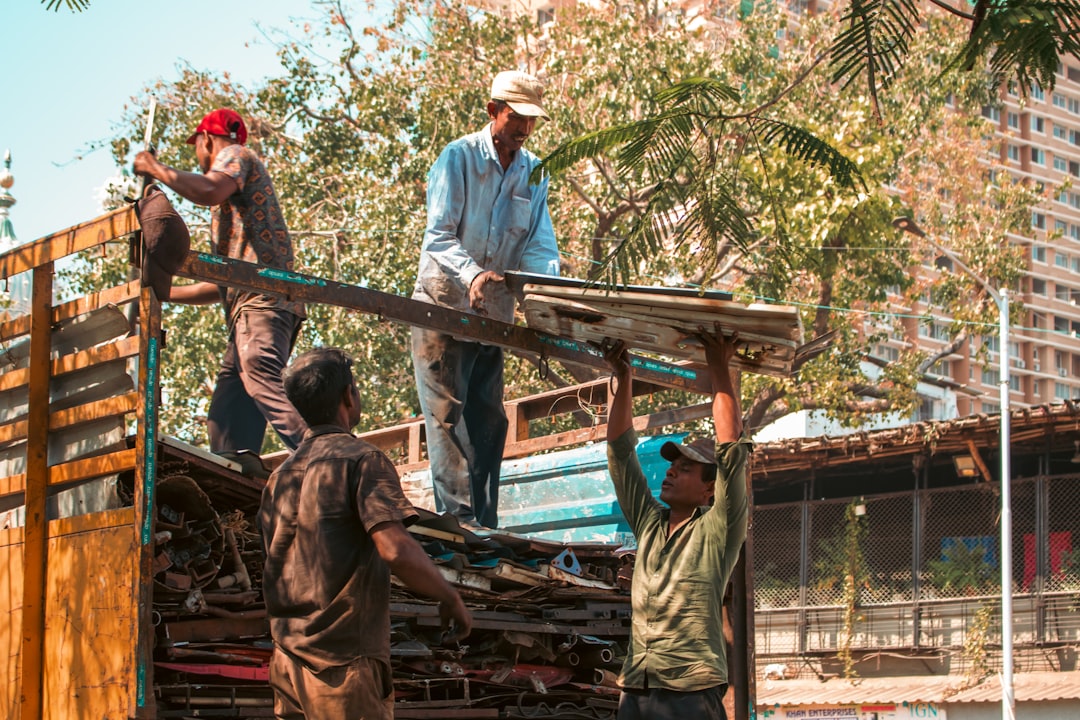 Roofing and framing crew working on a ladder at a Florida construction site during an OSHA compliance review