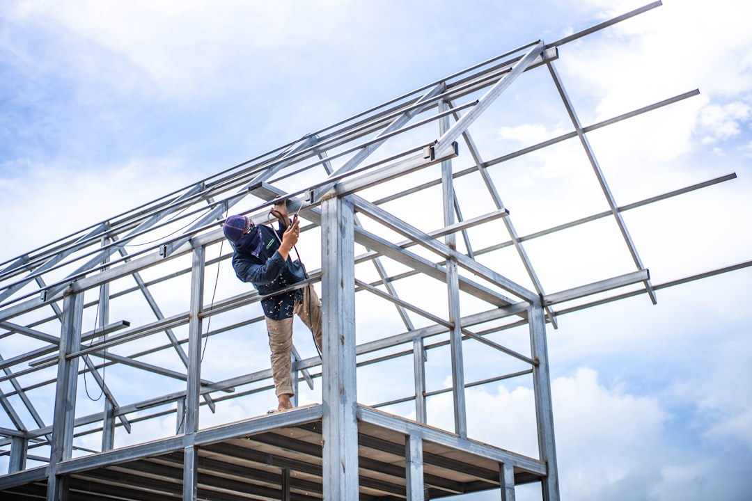 Roofing contractor climbing an extension ladder on a Virginia jobsite during an OSHA ladder safety inspection