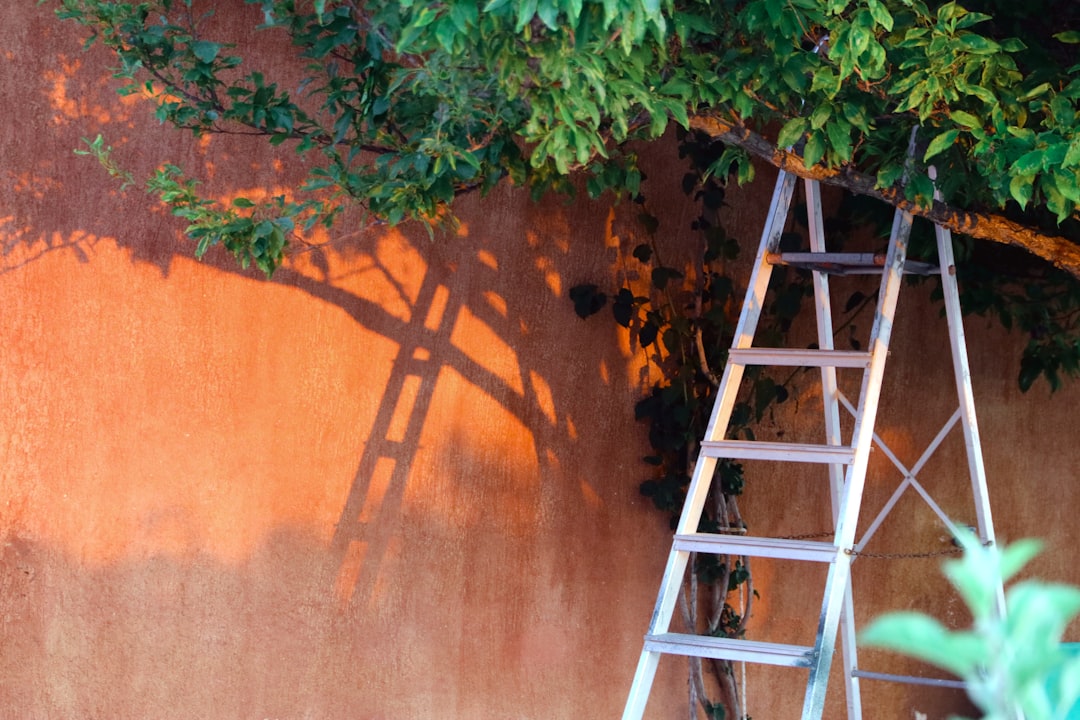 Roofing contractor using an extension ladder on a residential job site in Wisconsin, illustrating OSHA ladder violation risks