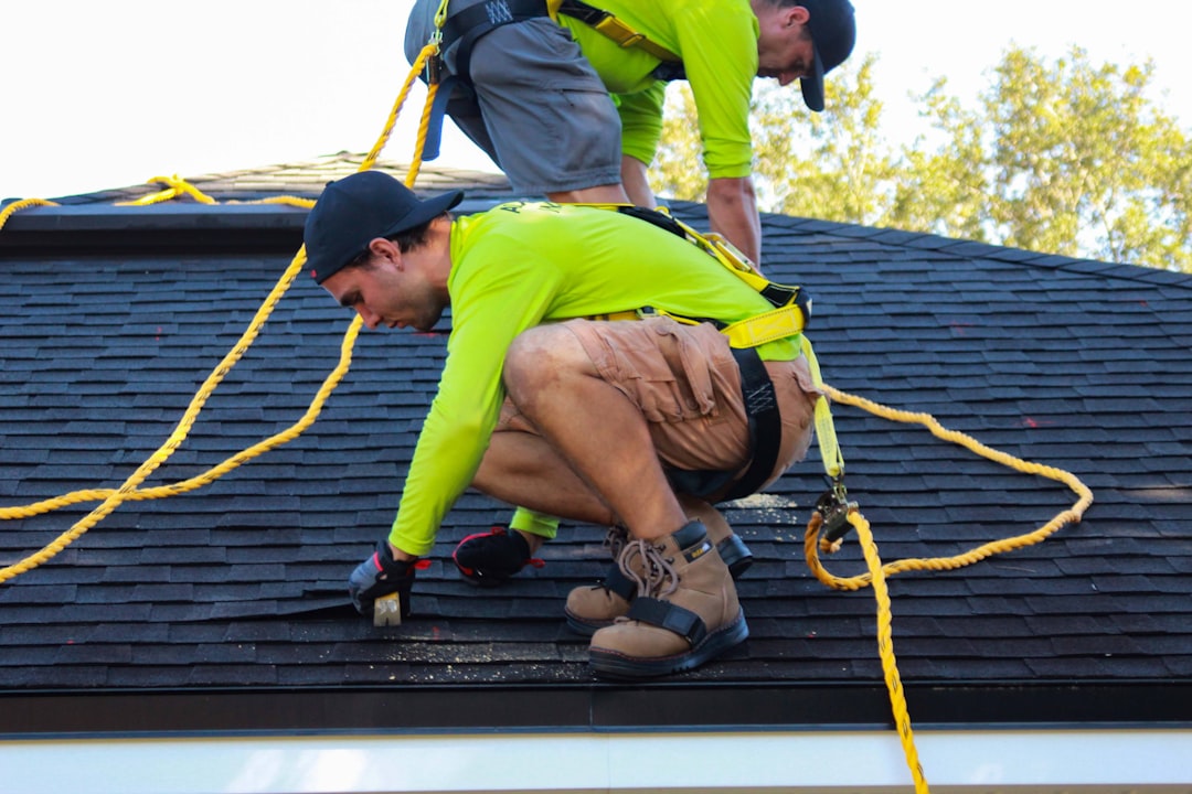 Roofing contractor working from an extension ladder on a Texas jobsite, the type of setup cited under OSHA's ladder standard