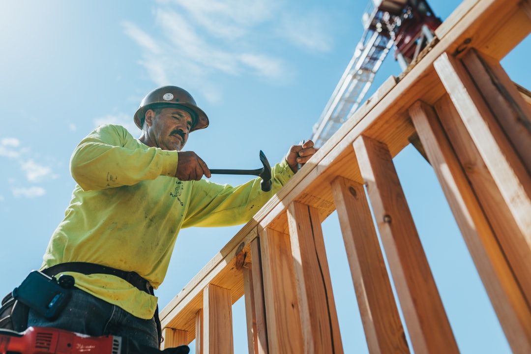Roofing contractor working at height on a Michigan construction site without visible fall protection