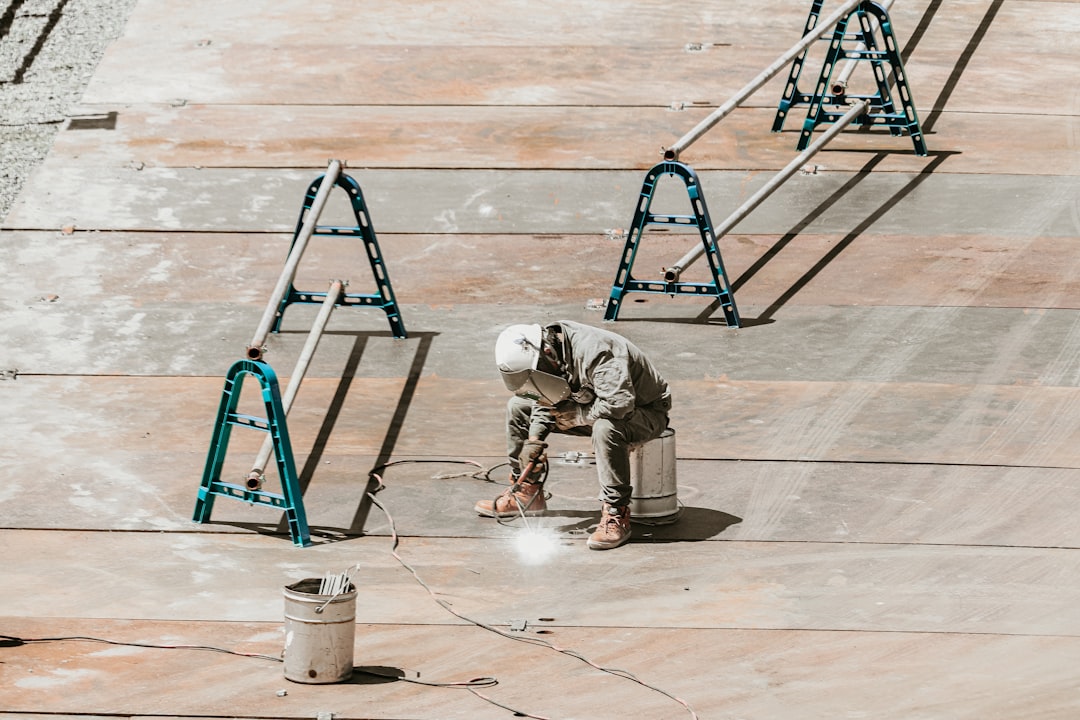 Roofing contractor working at height on a Hawaii job site without fall protection equipment