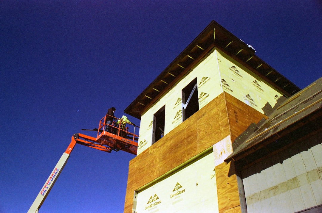 Roofing contractor working at height on a residential job site in Vermont without visible fall protection