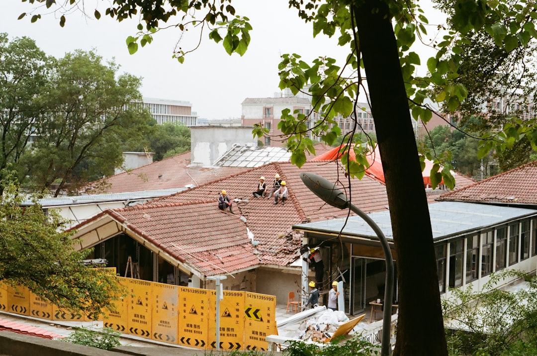 Roofing contractor working at height on a Florida construction site without visible fall protection equipment