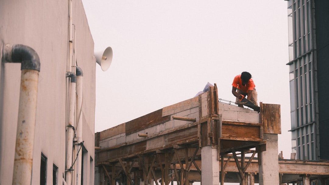 Roofing contractor working at height on a Montana job site without fall protection equipment