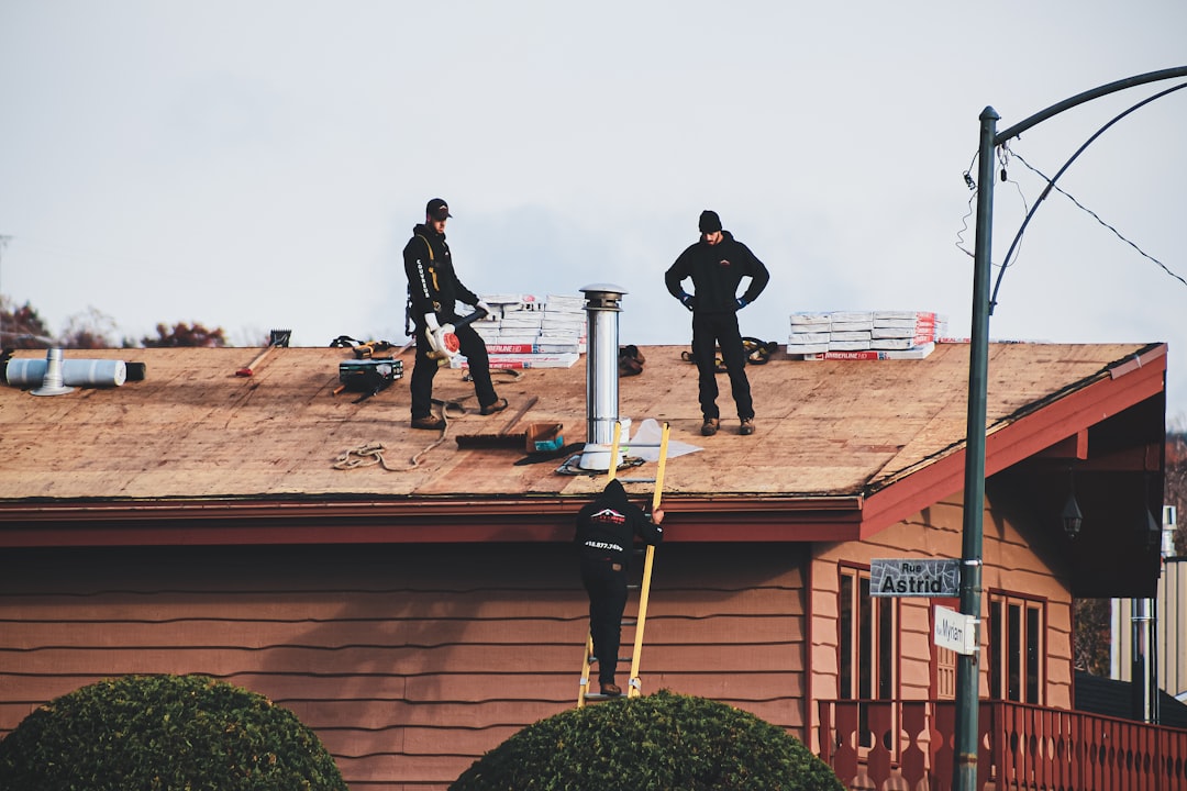 Roofing contractor working at height on an Oklahoma job site without visible fall protection
