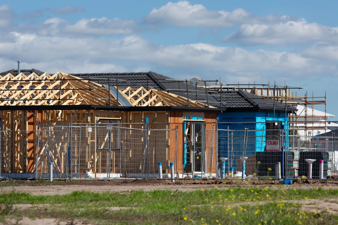 Roofing contractor working on scaffold platform at a construction site in Rhode Island