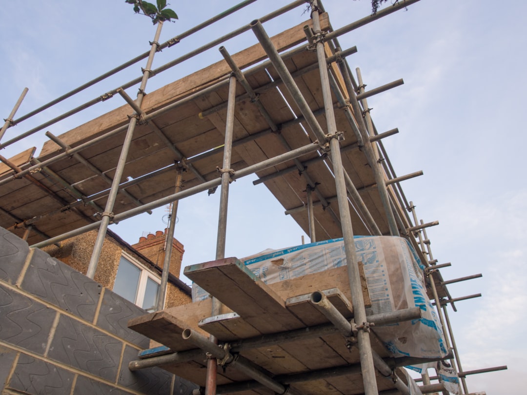 Roofing contractor working on scaffolding at a construction site in North Dakota
