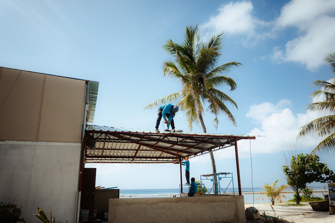 Roofing contractor working at height on a California construction site without visible fall protection