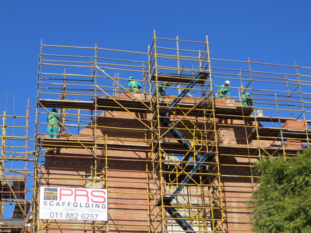 Siding contractor working on scaffolding at a Maryland construction site