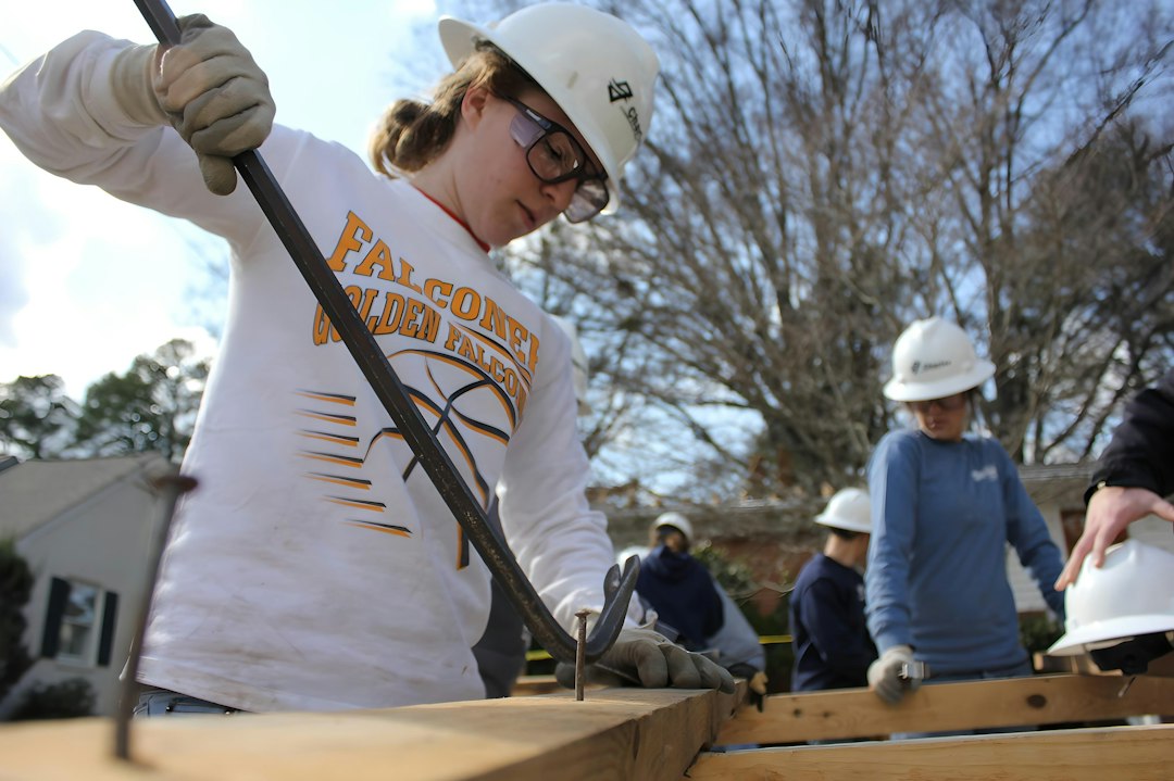 Framing contractor climbing a ladder on a residential construction site in Idaho