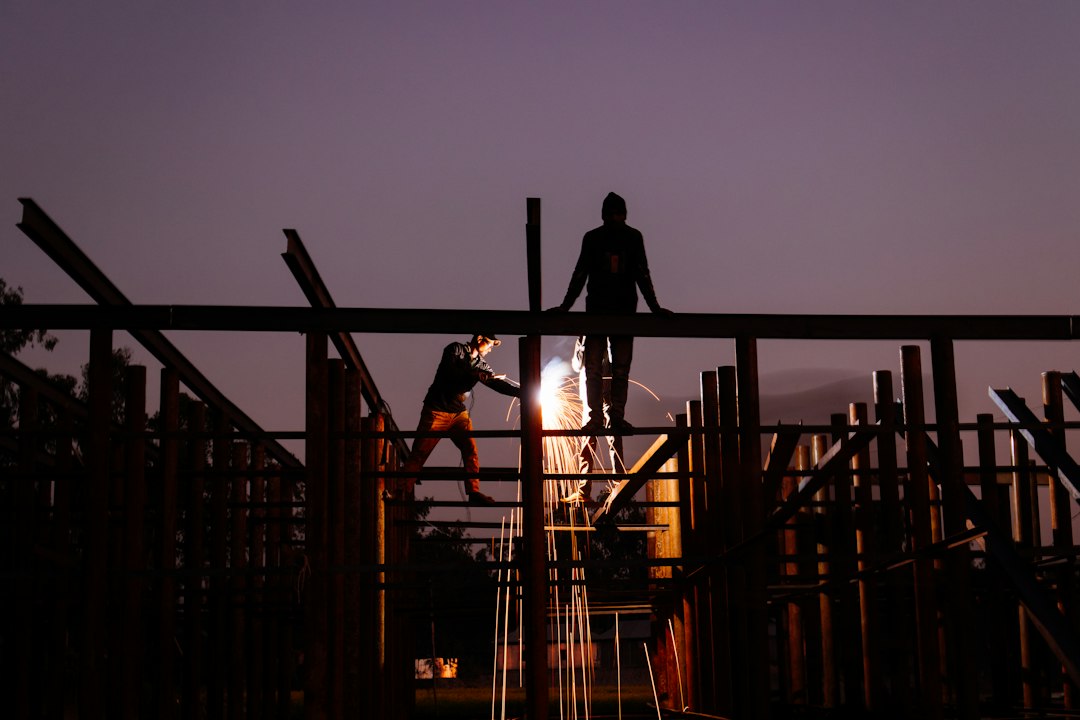 Framing contractor climbing a ladder on a residential job site in Georgia, the setup type most cited under OSHA's 1926.1053 ladder standard