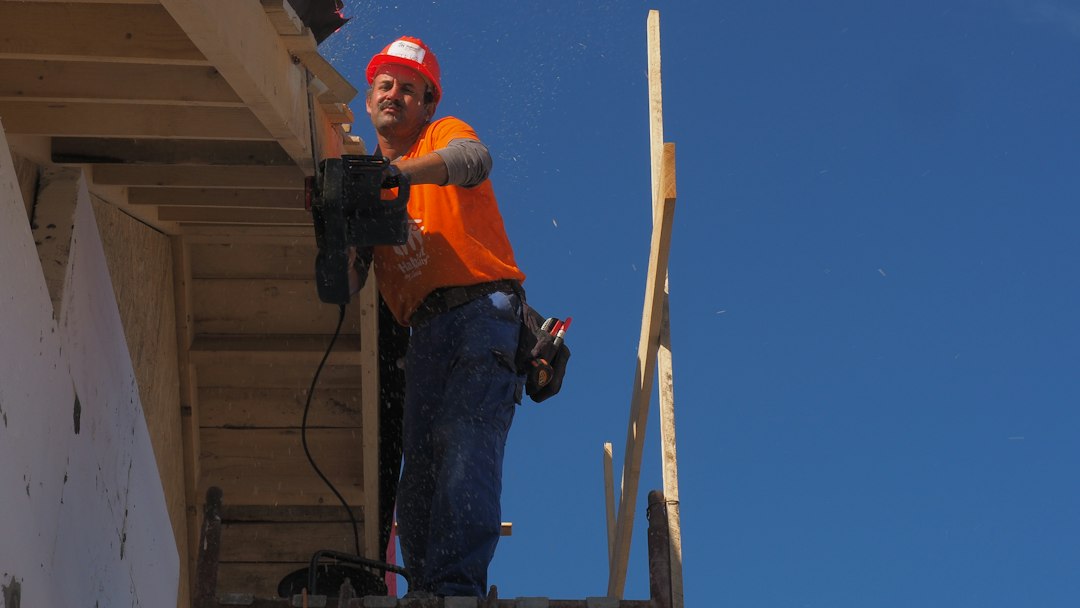 Framing contractor working at height without fall protection on a North Carolina construction site