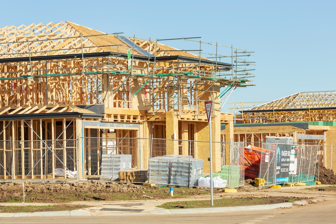 Roofing contractor working at height on a Florida construction site without visible fall protection, illustrating an OSHA fall protection violation