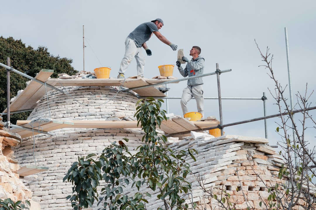 Roofing contractor working at height on a Maryland construction site without fall protection equipment