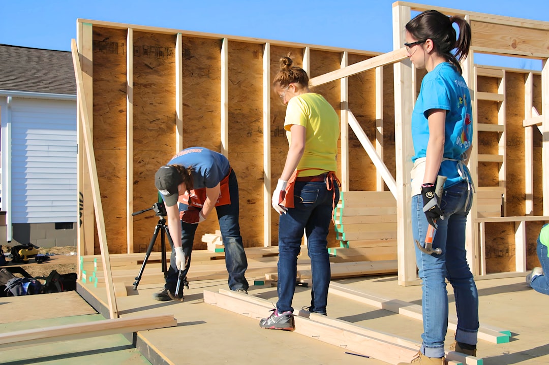 Roofing contractor climbing an extension ladder on a job site in Oklahoma, illustrating an OSHA ladder violation citation