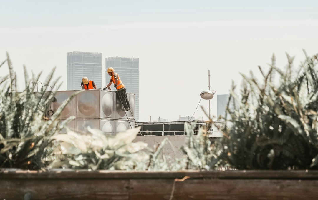 Roofing contractor working at height on a Hawaii construction site without visible fall protection, illustrating OSHA 1926.501 citation risk